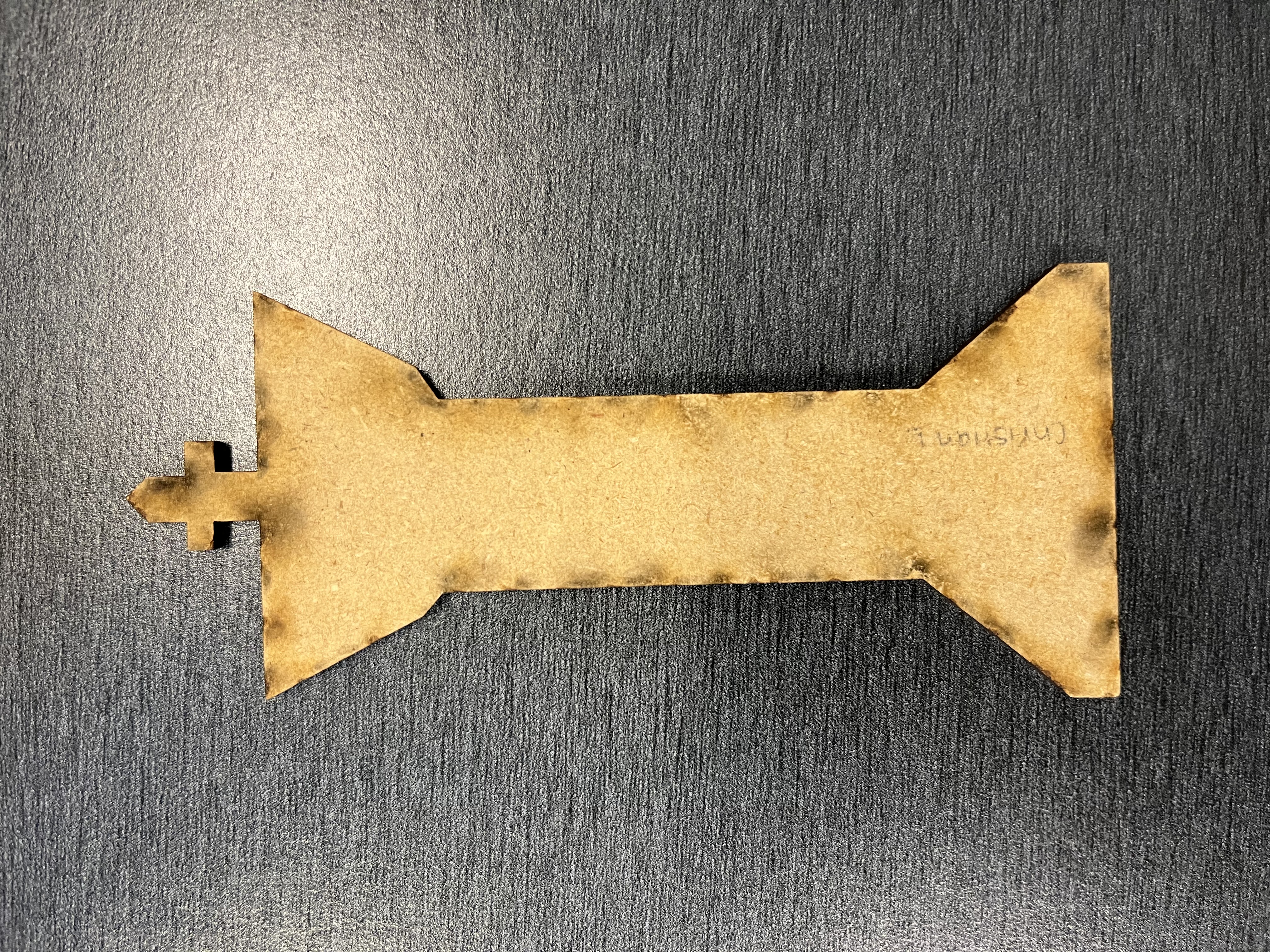 A laser-cut wooden keychain designed by a student in the workshop