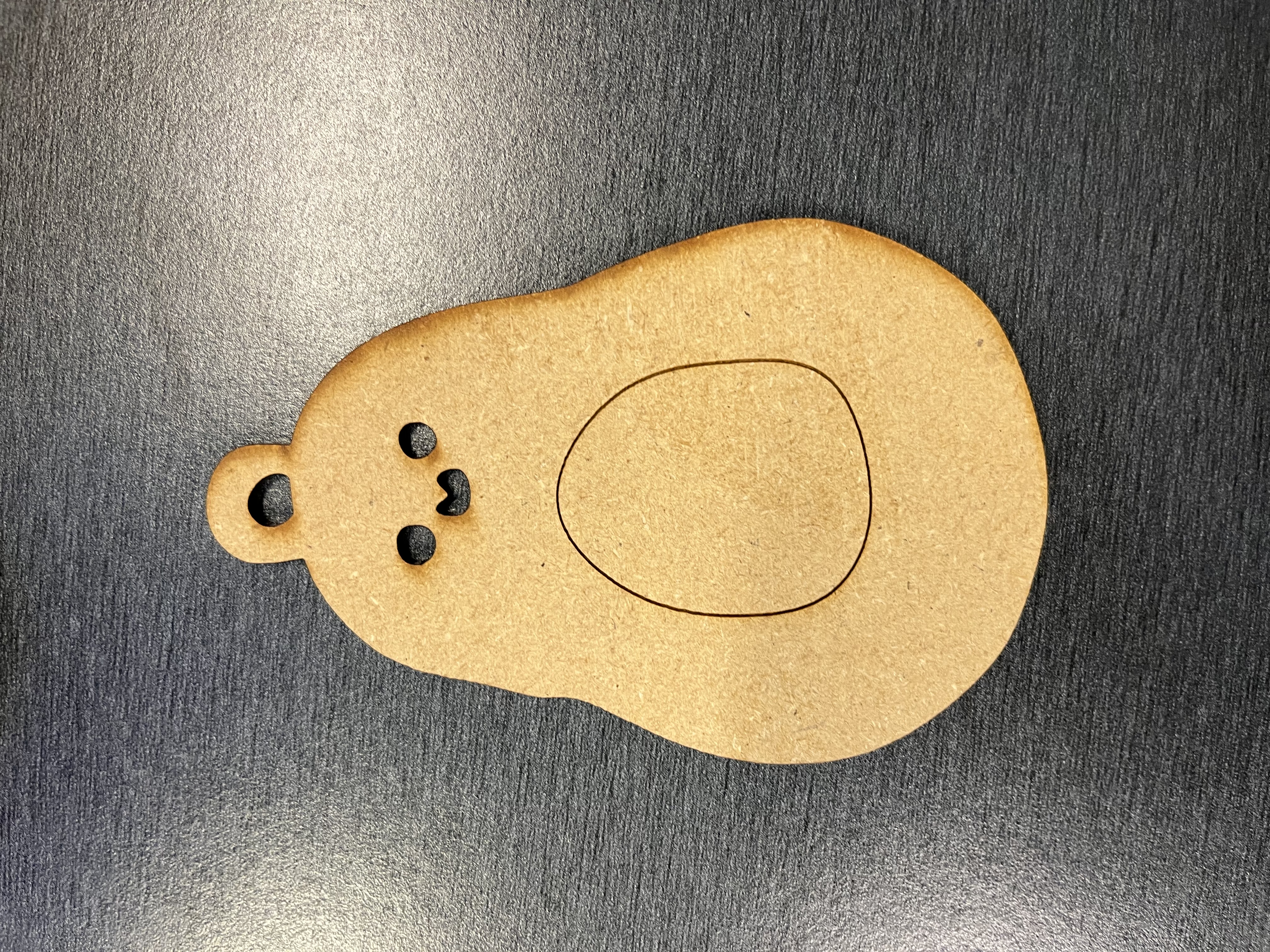 A third laser-cut keychain design from the workshop